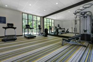 a gym with several treadmills and machines in a room at Four Points by Sheraton Birmingham Homewood in Homewood
