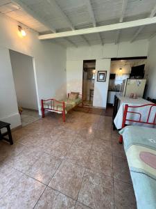 a room with a room with two beds and a kitchen at Las Retamas in Chapadmalal