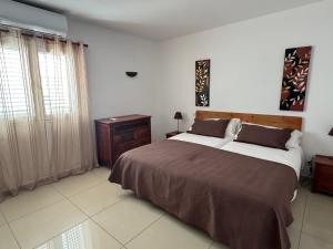 科拉雷侯Vivienda Vacacional Casa Lina的一间卧室配有一张大床和一个床头柜