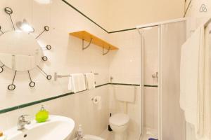 a bathroom with a sink and a toilet and a shower at Casa Martina in Pescara +11 photos
