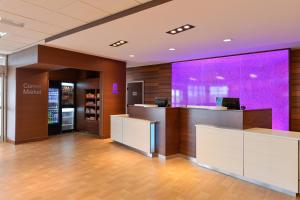 an office with a reception desk and a purple wall at Fairfield Inn & Suites by Marriott Gallup in Gallup +20 photos