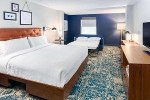 Rúm í herbergi á Four Points by Sheraton Eastham Cape Cod