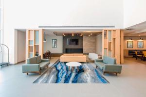 a lobby with a large painting on the floor at Fairfield Inn & Suites by Marriott Tijuana in Tijuana