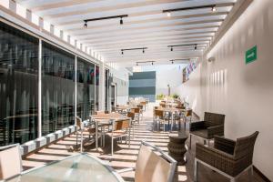 a restaurant with tables and chairs on a balcony at Fairfield Inn & Suites by Marriott Tijuana in Tijuana