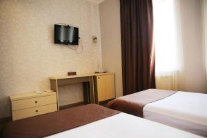 Postel nebo postele na pokoji v ubytování Rondo Hotel