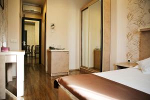 Postel nebo postele na pokoji v ubytování Rondo Hotel