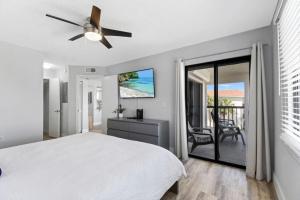 a bedroom with a bed and a ceiling fan at Oceanside complex M33 1 Bed 1 Bath Heated Pool in Saint Augustine +36 photos