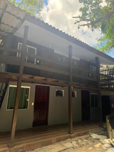 a building with a lot of windows and doors at Pousada Casa do Nilo in Ilha do Mel
