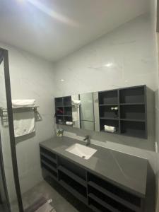 a bathroom with a sink and a mirror at Hotel Plaza Corotú-HPC in Santiago +28 photos