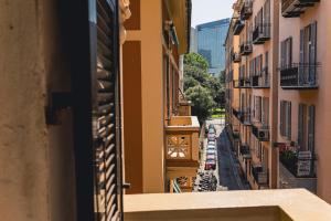 a view of a street with a clock on a building at palmaria suite -the duck nest in Genoa