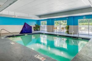 a swimming pool in a building with blue walls at Fairfield Inn Myrtle Beach North in Myrtle Beach