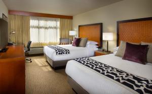 a hotel room with two beds and a desk at The Paramount Hotel in Seattle +34 photos