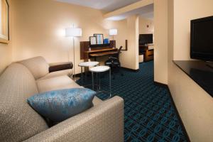 a hotel room with a couch and a desk at Fairfield Inn & Suites Idaho Falls in Idaho Falls