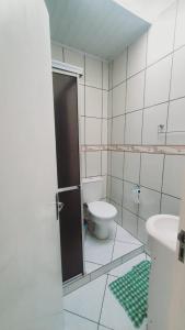 a bathroom with a toilet and a sink at Aluguel de Verão in Torres
