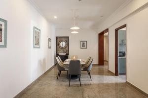 a dining room with a table and chairs at Emerlad Apartment 201 Nr MG Road Housekeeping in Bengaluru +16 photos
