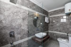 a bathroom with a sink and a toilet and a shower at Emerlad Apartment 201 Nr MG Road Housekeeping in Bengaluru