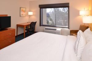 a hotel room with a bed and a desk and a window at Fairfield Inn & Suites Hattiesburg / University in Hattiesburg +17 photos