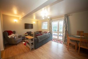 a living room with a couch and a table at Pheasant's Bank holiday cottage in Chapel en le Frith