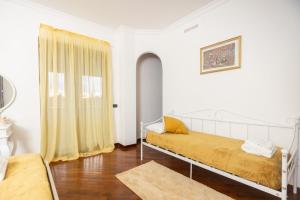 a white room with a bed and a window at Villa Maria Pia in Aranova