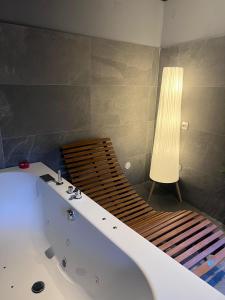a bathroom with a bath tub with a light next to it at VILLA Como, Jacuzzi Spa and Private Pool in Blevio +33 photos