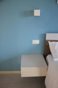 Postel nebo postele na pokoji v ubytování B&B Il Melograno