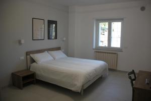 Postel nebo postele na pokoji v ubytování B&B Il Melograno