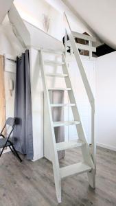 a ladder leading up to a loft bed in a room at La Petite Parenthèse in Beure