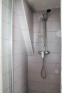 a shower with a shower head in a bathroom at La Petite Parenthèse in Beure +5 photos
