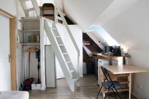 a room with a loft bed and a desk at La Petite Parenthèse in Beure