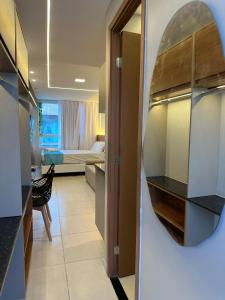 a room with a mirror and a room with a bed at EcoMirage - Flats Premium - Porto de Galinhas in Porto De Galinhas +25 photos
