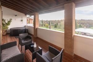 a balcony with chairs and tables and a large window at Villa Maria Pia in Aranova +39 photos