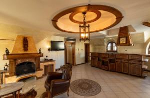 a large kitchen with a fireplace and a chandelier at Royal Casa in Belgrade