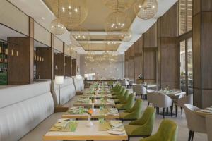 a long dining room with tables and chairs and chandeliers at Four Points by Sheraton Nairobi Airport in Nairobi