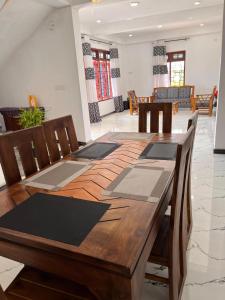 a wooden table with chairs and a dining room at The Off Road Homestay in Kandy +12 photos
