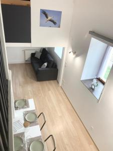 a living room with a couch and a table at Appartement proche gare in Sélestat