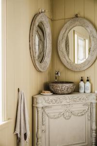 a bathroom with a sink and two mirrors on the wall at Montville Estate - Luxury Hinterland Home & Pool in Montville +34 photos