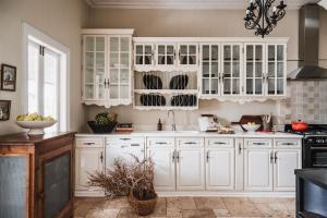 a kitchen with white cabinets and a sink at Montville Estate - Luxury Hinterland Home & Pool in Montville