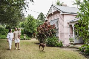 a family walking a dog in front of a house at Montville Estate - Luxury Hinterland Home & Pool in Montville
