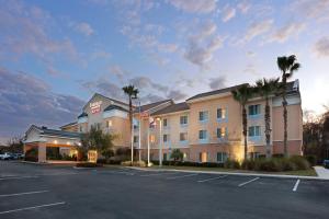 a hotel with palm trees in front of a parking lot at Fairfield Inn and Suites by Marriott Saint Augustine I-95 in St. Augustine