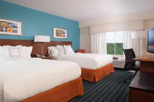 a hotel room with two beds and a flat screen tv at Fairfield Inn Greenville Spartanburg Airport in Greenville +12 photos