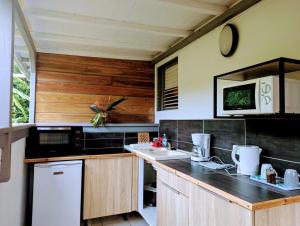 a kitchen with wooden cabinets and a counter top at Sur L'Anse in Terre-de-Haut