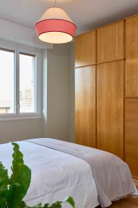 a bedroom with a large bed and a wooden cabinet at Your Milan Home in Milan