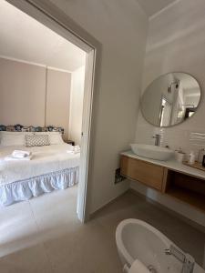 a bathroom with a bed and a sink and a mirror at Cute Villa with pool in Palau in Palau