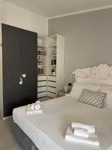 a bedroom with a bed with two towels on it at Cute Villa with pool in Palau in Palau