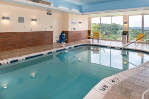 a swimming pool with blue water in a building at Fairfield Inn & Suites by Marriott Huntington in Huntington