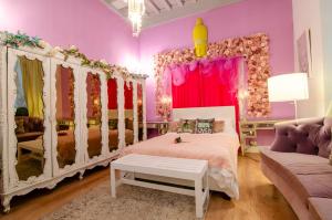a pink bedroom with a bed and a couch at One of a kind home with NYC views in Union City