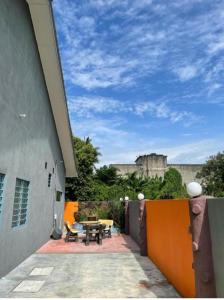 a patio with a picnic table and a castle in the background at RALI PD HOME D 16Pax karaoke and swimming pool in Port Dickson