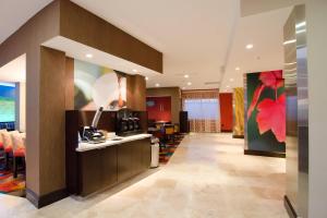 a lobby of a hotel with a kitchen and dining room at Fairfield Inn and Suites by Marriott North Spring in Spring