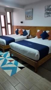 Postel nebo postele na pokoji v ubytování HOTEL CHURUMUCO