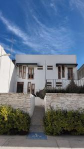 a white building with a fence in front of it at HOTEL CHURUMUCO in San José Iturbide